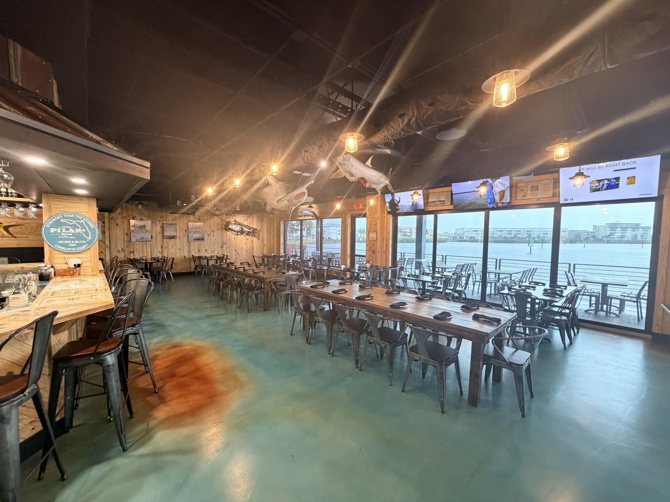 Leroy's Fish Shack dining room, waterfront tables and shark and tarpon mounts overhead